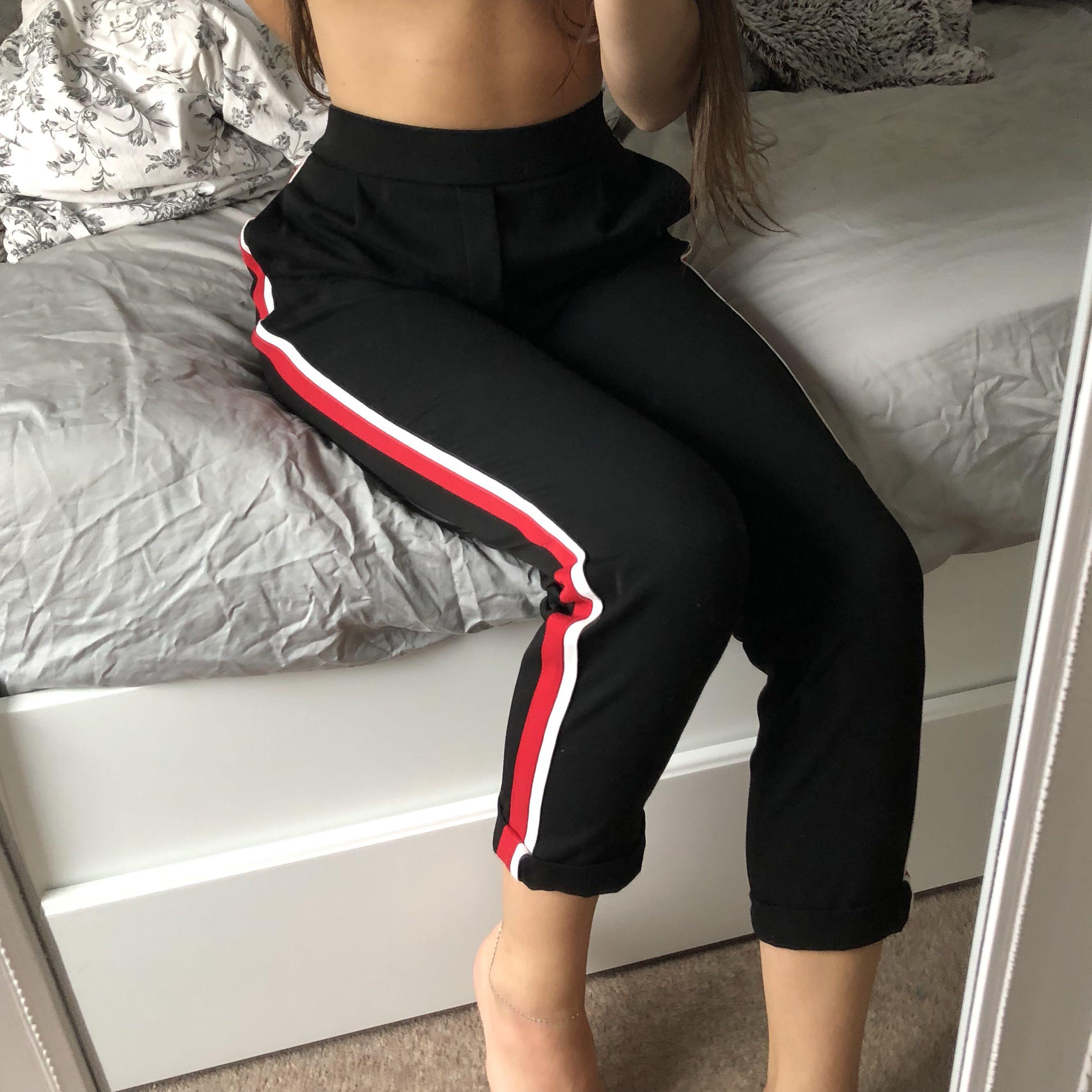 black pants with red and white stripe