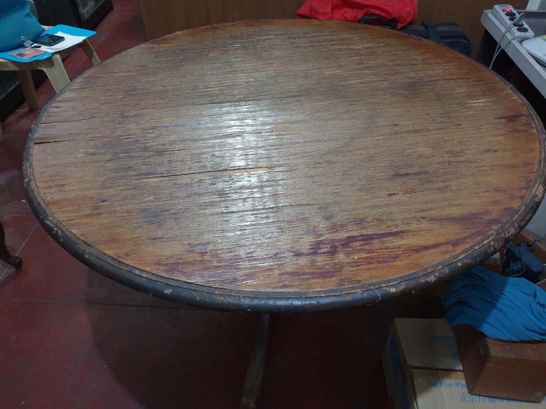 Round dining table (Category: Tables & Sets) located in Quezon City. Submitted by elementalforge (Listing ID 1038446375, Image 3). Description: selling a very good old round dining table that can fit 5-6 persons. Please take note of the pictures to show its wear and tear over the years. this table is a good antique and its more than 20 years asxa sort of a family heirloom. The top parapet/surface may need some repair but the base and tabletop sup