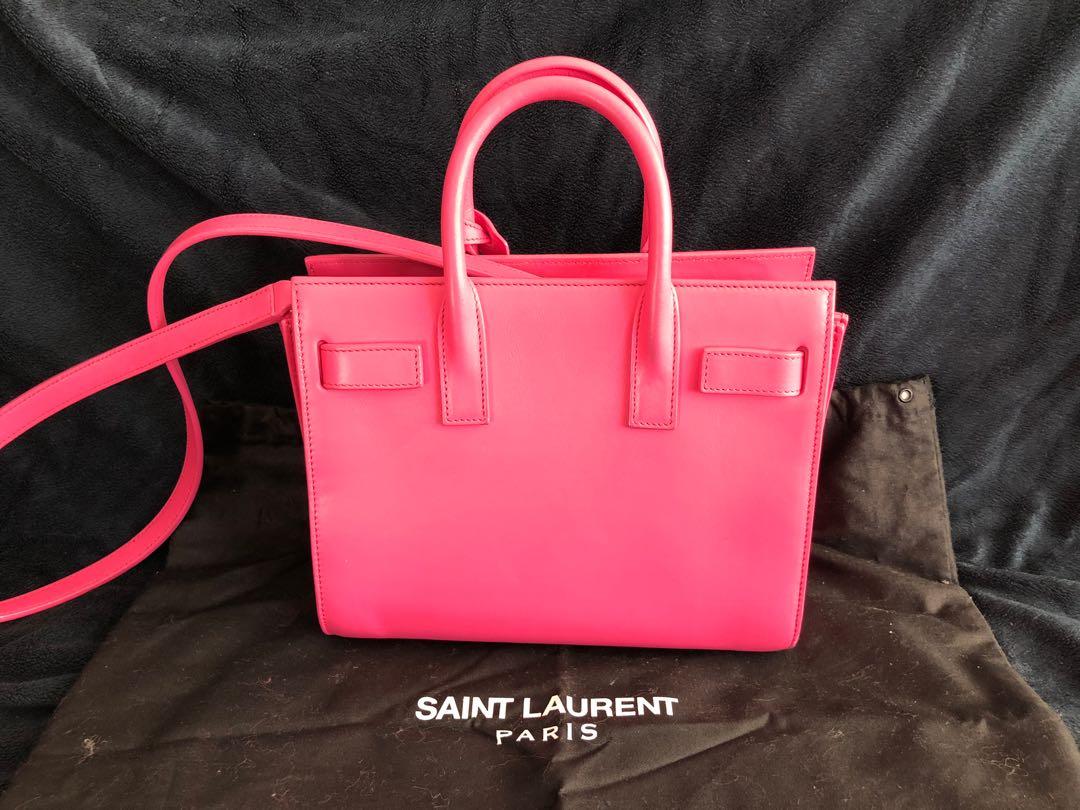 Saint Laurent Sac de Jour Bag Leather Nano (Category: Bags & Wallets) located in Toronto. Submitted by cheongaaz (Listing ID 1033595979, Image 2). Description: This is an authentic SAINT LAURENT Calfskin Nano Sac De Jour Lipstick Fuchsia. This structured mini tote is crafted of smooth calfskin leather in a bright, fun bubblegum pink. The bag features accordion style sides and rolled leather top handles with an optional long crossbody leather shou