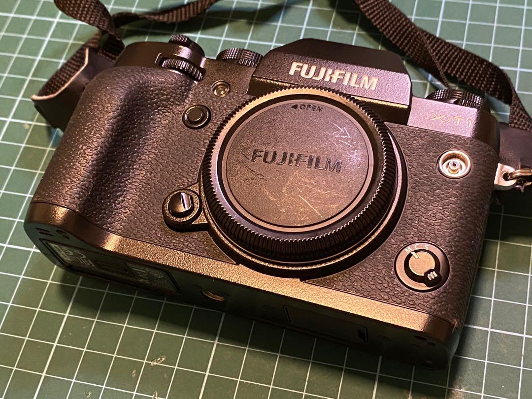 Fuji XT1 body with 4 original batteries, mini flash, leather jacket and