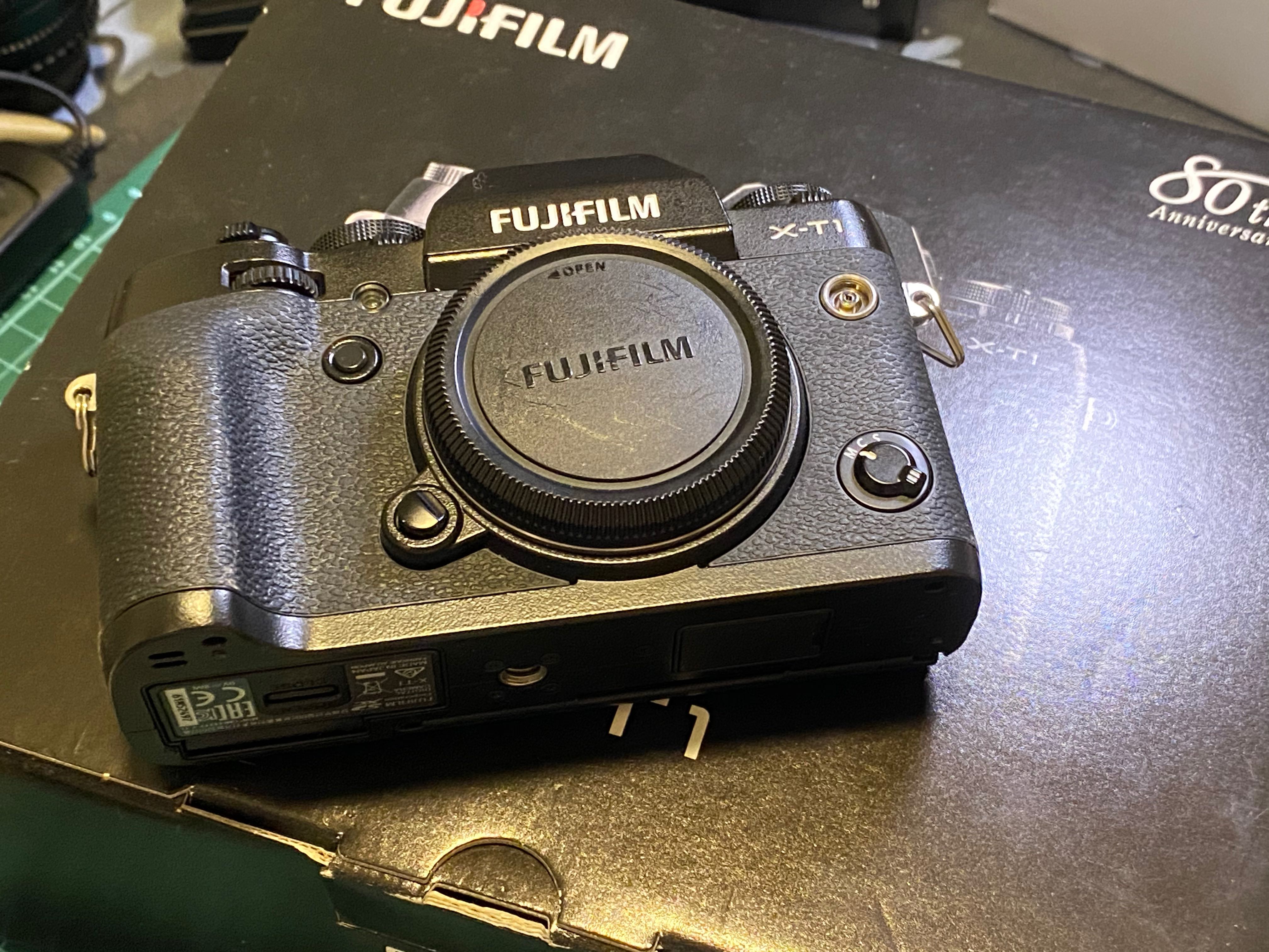 Fuji XT1 body with 4 original batteries, mini flash, leather jacket and
