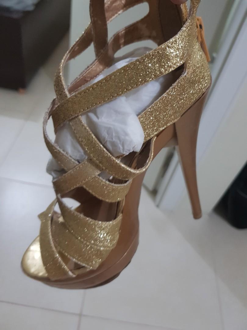 Gold glittering high heels still with 