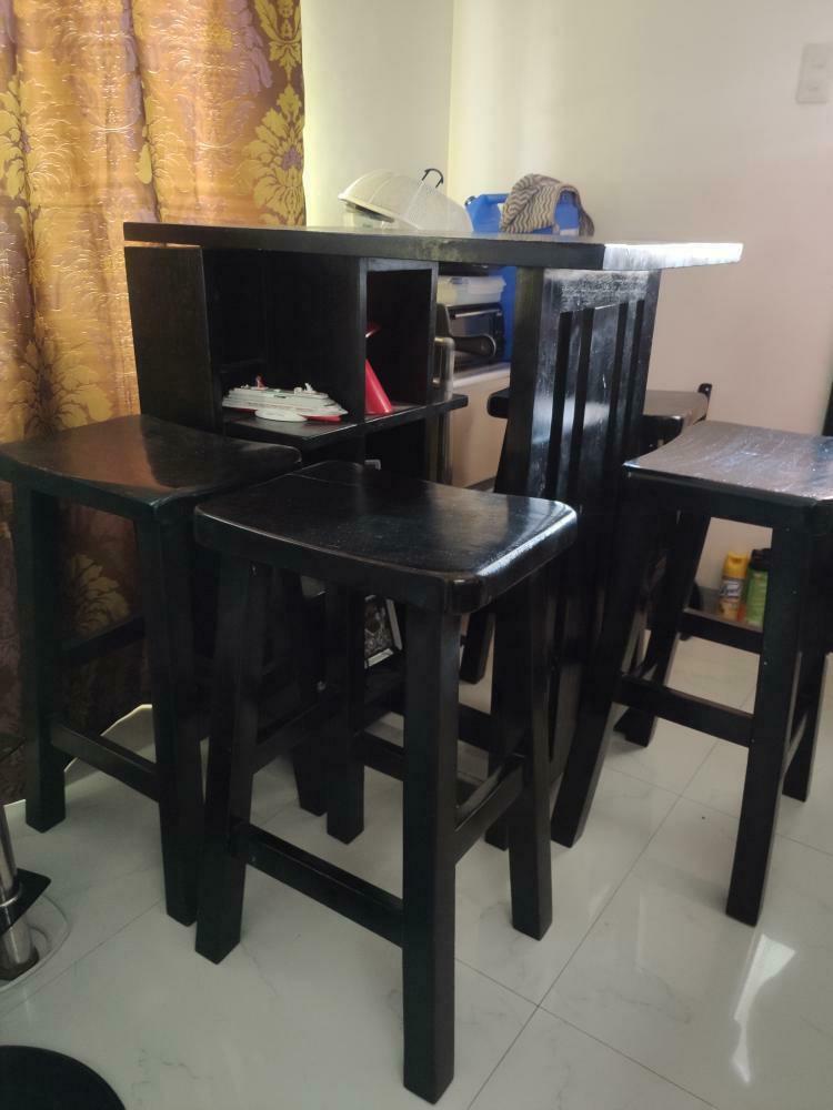 Dining table (bar type) (Category: Tables & Sets) located in Imus. Submitted by camstamayo92 (Listing ID 1063673698, Image 3). Description: RUSH (for pickup) Selling our 7yr old dining (bar type - high chair and table) Please see pics and caption for more details. * made of mahogany * 4 high chairs * with display rack on the side RFS: Sikip na sa bahay as you can see sa pic daming gamit bought for 16k (own design) Issues: Need to repaint There ar