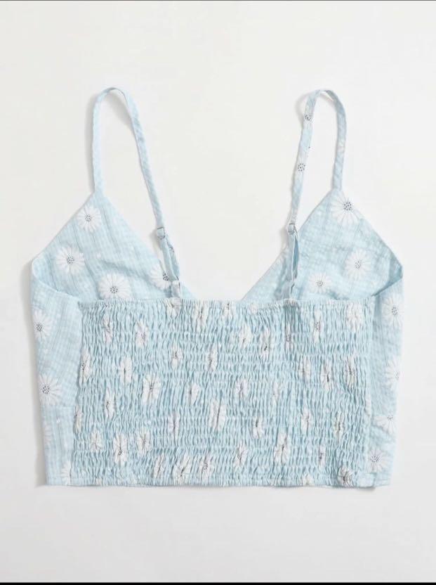 Shein Blue Top (Category: Sleeveless) located in Cainta. Submitted by _theclutter (Listing ID 1063968038, Image 2). Description: Shein Daisy Floral Smocked Cropped Cami Top (small) Got the pictures from the shein app. The top looks exactly like the pictures. Sizing runs a little big, i’m usually a small to medium so this top would cater to medium or large (in my opinion). You may refer to the chart but please do so w caution..