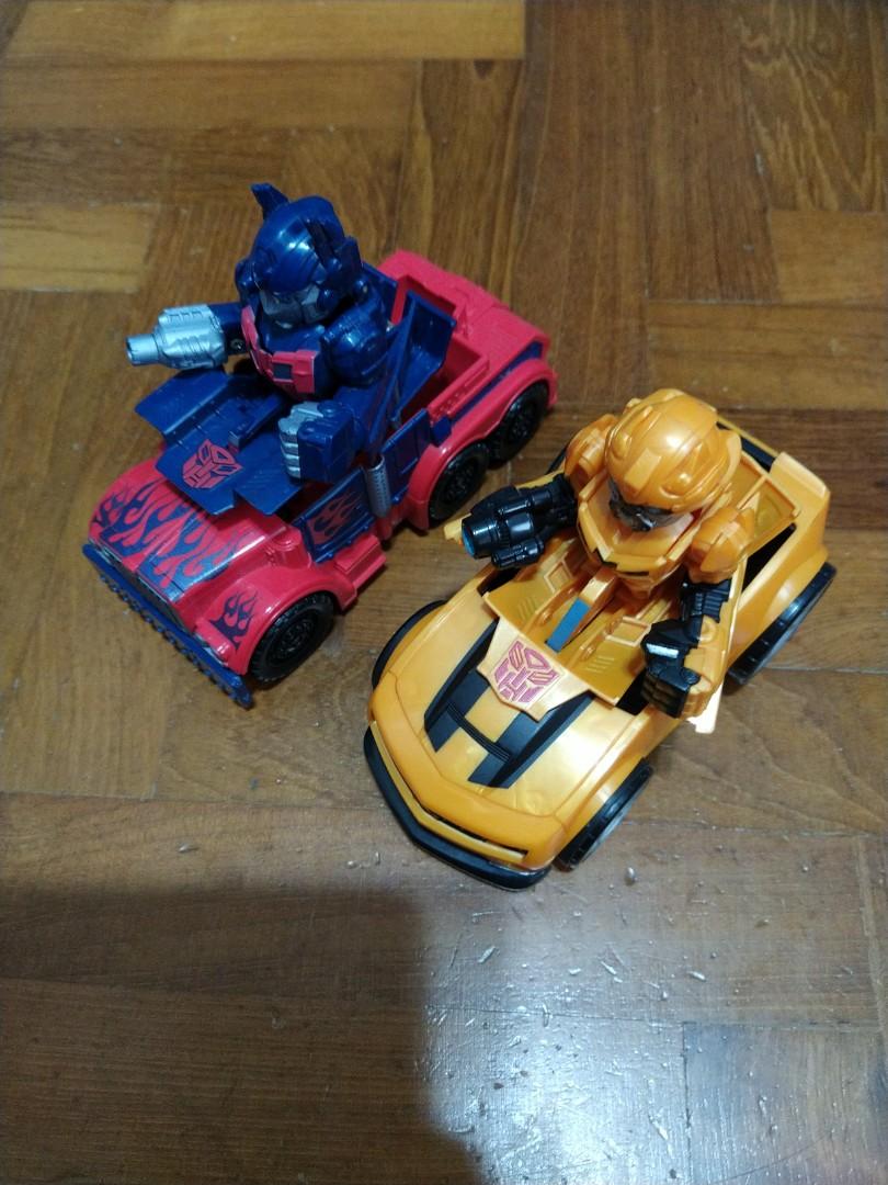 Transformers (Category: Toy Figures) located in Singapore. Submitted by neoamly (Listing ID 1064012076, Image 2). Description: 2 transformers toys for children. Has wind-up mechanism for forward mobility. Overall in good condition. Not for fussy..