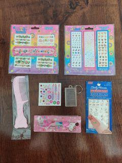 Assorted items: Lisa frank nail stickers, sally hansen nail stickers, hello kitty multi-pen, barbie stickers, hello kitty comb, keychain