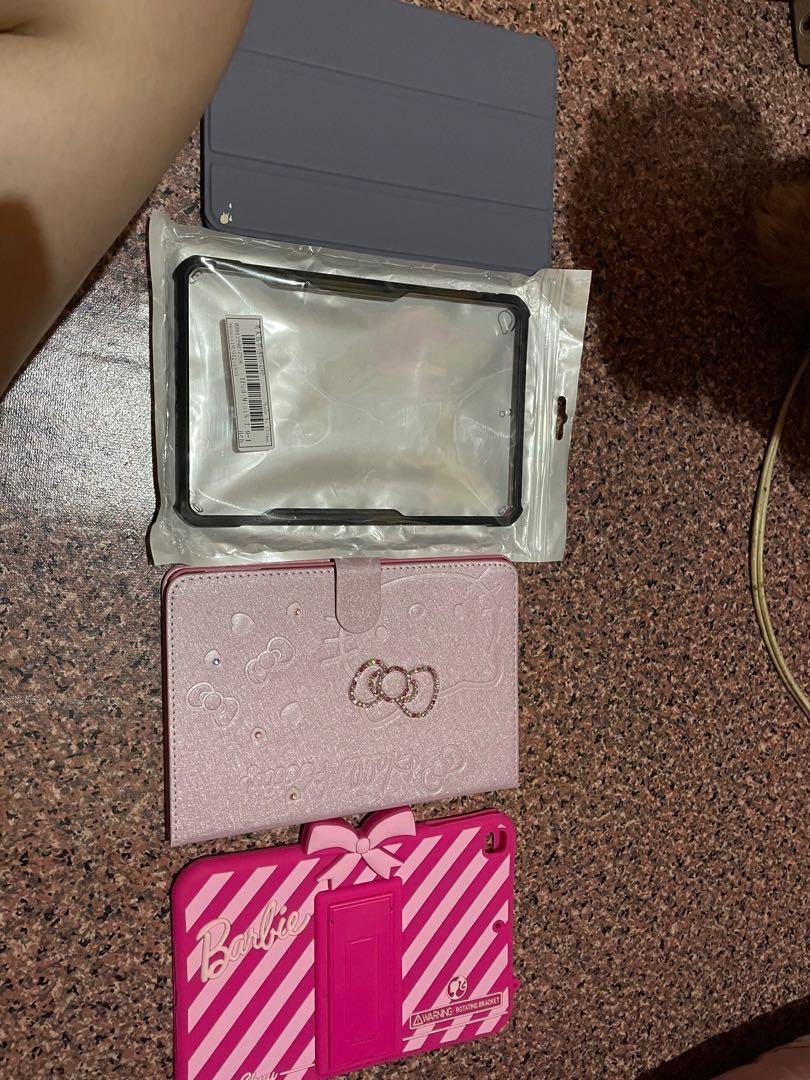 Ipad mini 5 cases (Category: Cases & Sleeves) located in Manila. Submitted by cocothrifts (Listing ID 1065721922, Image 2). Description: Decluttering naaa Hello kitty brandnew 400 Zunod case 200 Barbie 200 Flip cover 150.