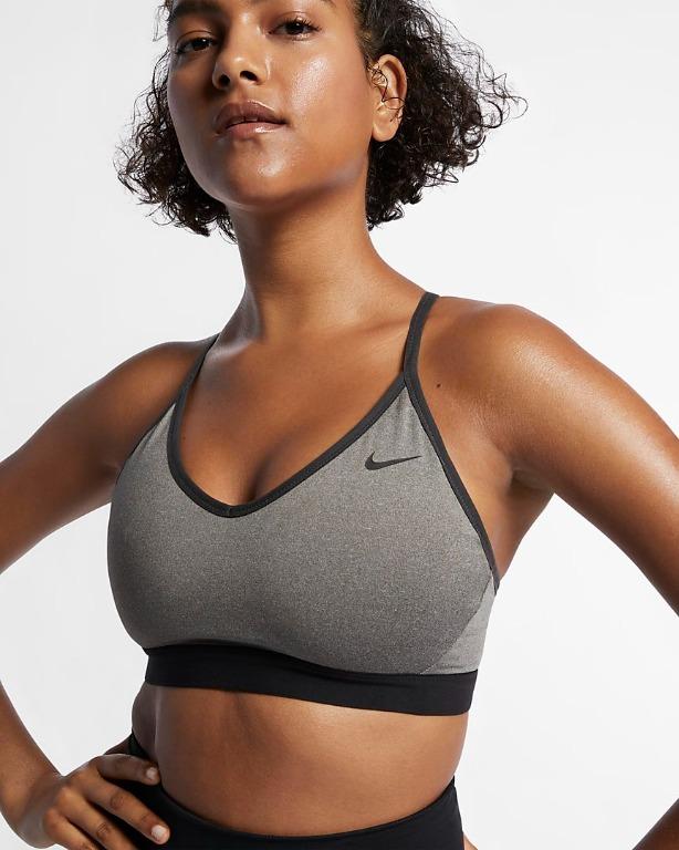 Women's Nike Indy Sports Bra offers light support during low-impact,  high-enegry workouts such as Pilates, barre and yoga. The low-cut design  and thin, adjustable straps provide feminine detail while the back mesh