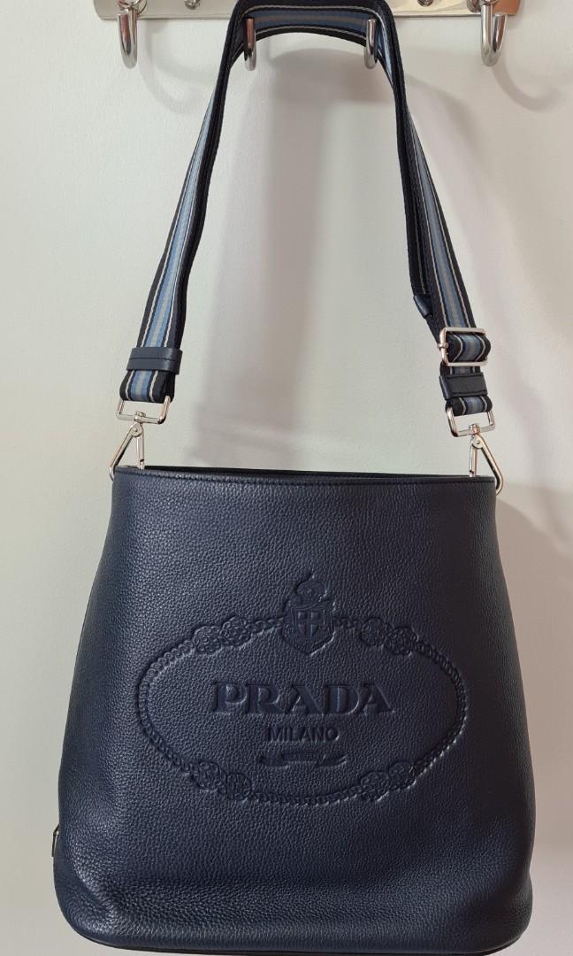 Prada 1BE023 Vitello Secchiello Blue Leather Embossed Logo Crossbody Bag,  Women's Fashion, Bags  Wallets, Cross-body Bags on Carousell