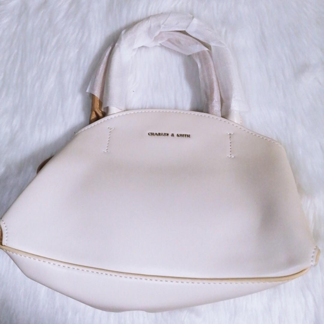 Charles and keith 2 white and tan (Category: Beach Bags) located in Pasay City. Submitted by wardrobe_clearing (Listing ID 1061624757, Image 1). Description: Brand new With dust bag Mall pullout.