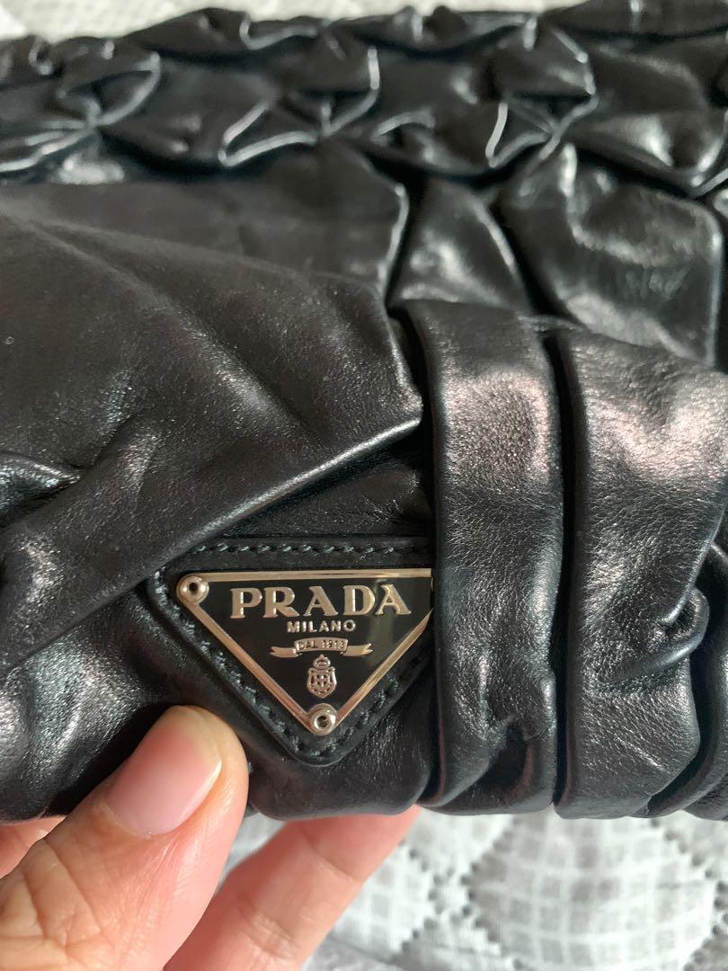 Prada envelope bag (Category: Luxury Bags & Wallets) located in Makati City. Submitted by myterry1941 (Listing ID 1061572594, Image 2). Description: Comes with dust bag and bag Please check condition of the interior of the bag before making an offer Interior lining needs to be sewn Authenticity cards and tag included .