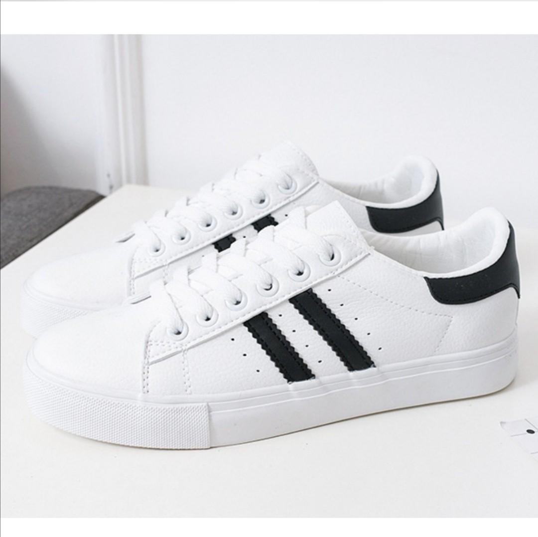 White sneakers with best sale black stripes