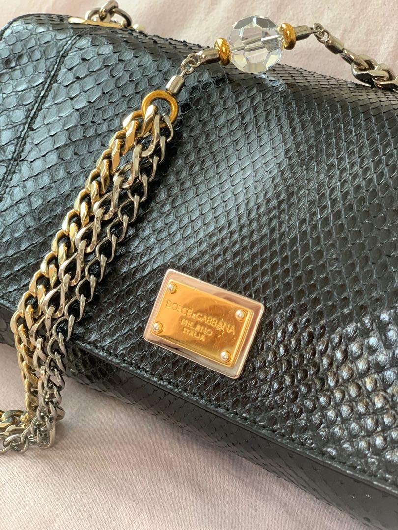 D&G Miss Charles Python clutch/shoulder bag (Category: Luxury Bags & Wallets) located in Taguig. Submitted by zablaza (Listing ID 1119590125, Image 2). Description: Rare authentic D&G Miss Charles python clutch/shoulder bag w/ crystal faux-pearl embellished chain. Red satin interior lining w/ single interior pocket & snap closure at front flap. Excellent pre-owned condition. Comes w/ dust bag & authenticity card..