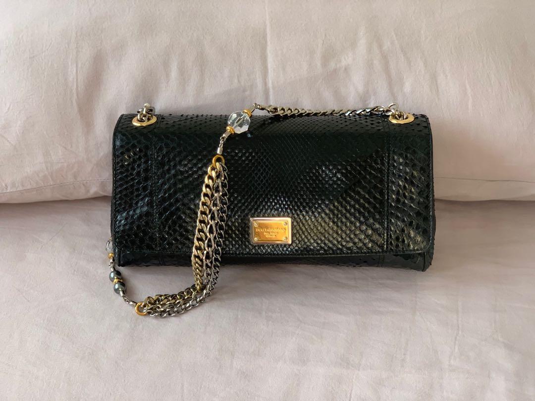 D&G Miss Charles Python clutch/shoulder bag (Category: Luxury Bags & Wallets) located in Taguig. Submitted by zablaza (Listing ID 1119590125, Image 1). Description: Rare authentic D&G Miss Charles python clutch/shoulder bag w/ crystal faux-pearl embellished chain. Red satin interior lining w/ single interior pocket & snap closure at front flap. Excellent pre-owned condition. Comes w/ dust bag & authenticity card..