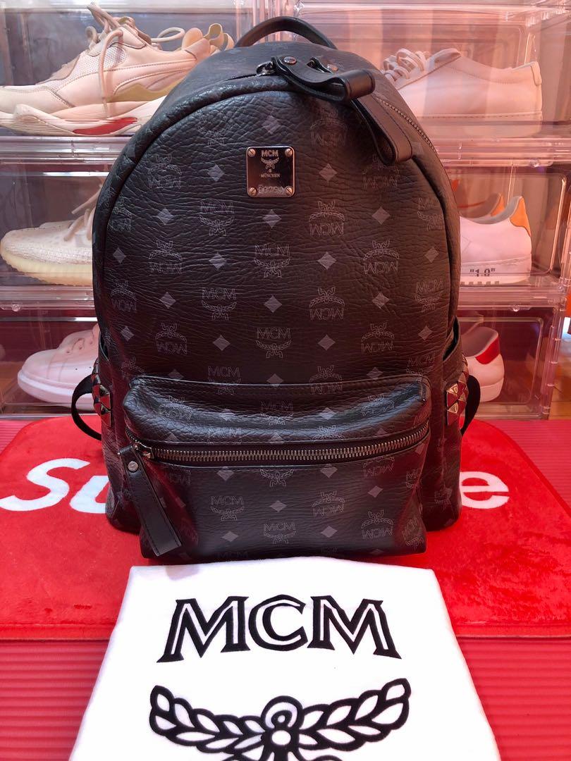 Mcm black outlet and red backpack