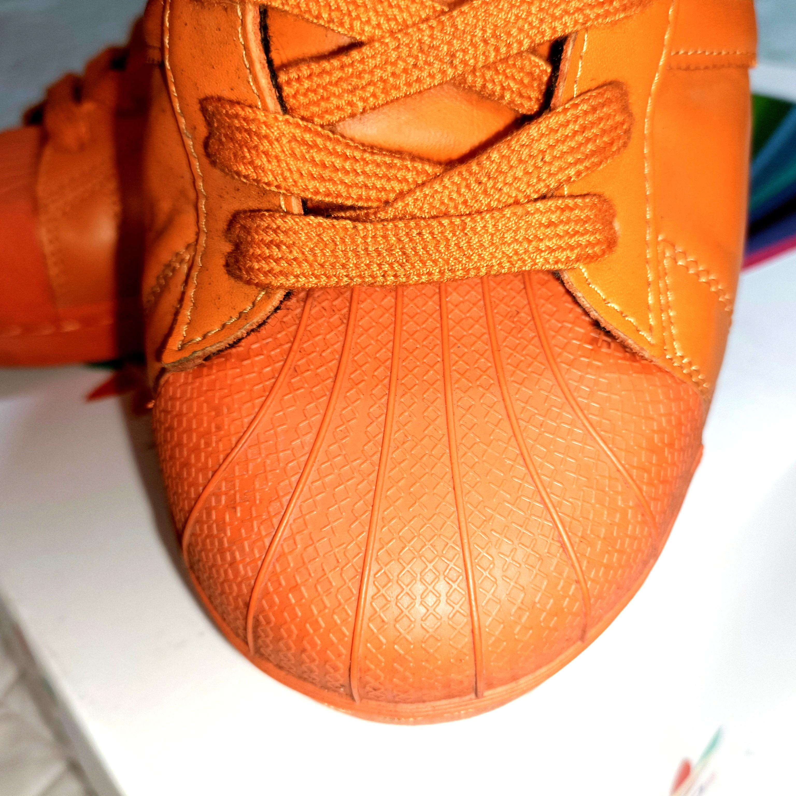 Orange adidas superstar top supercolor