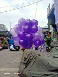 purple flying helium balloon
