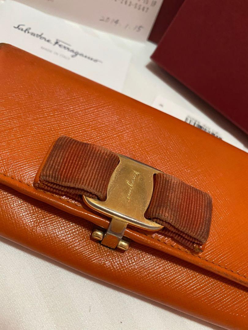 FASTBREAK! Salvatore Ferragamo Wallet (Category: Luxury Bags & Wallets) located in San Fernando. Submitted by thehamiltonqueen (Listing ID 1121415299, Image 2). Description: Original Salvatore Ferragamo Long Wallet Color:Orange Hardware: Gold Inclusion: Box,Tissue Wrap,Cards, and barcode Signs of Usage: Oxidized corners, darkened front ribbon, and scratches on the hardware Recommend to have this bag spa to bring bag its beauty. No stickiness, no 