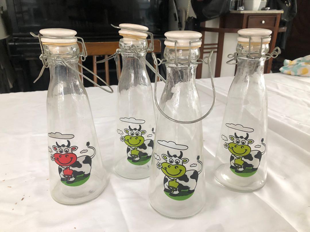 Glass Milk Bottles with Seal (Category: Pitchers & Dispensers) located in Manila. Submitted by lts125 (Listing ID 1122619542, Image 1). Description: Store milk fresh and spill-free with these milk bottles with silicon sealer. 4 have cow design, 1 with intricate white design. .