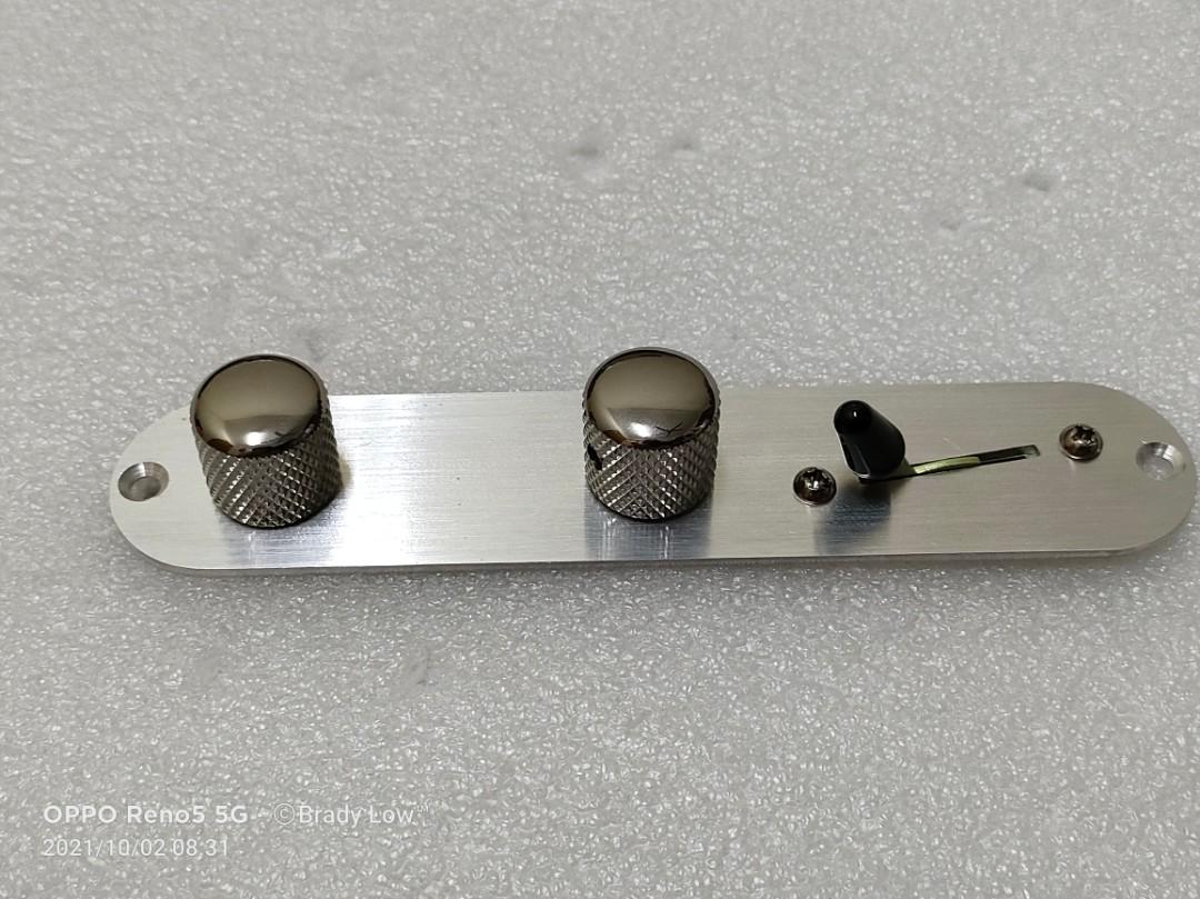 Angled telecaster outlet control plate