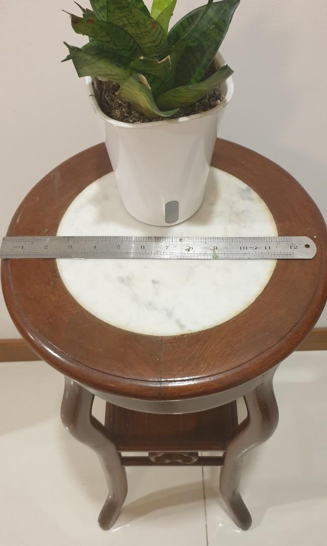 Solid wood side table (Category: Tables & Sets) located in Singapore. Submitted by joytp (Listing ID 1118358668, Image 1). Description: Nyatuk Wood with marble top, bought this in malacca, 35.5cm(width)x77cm (height), can last for many generations. for self collect only..