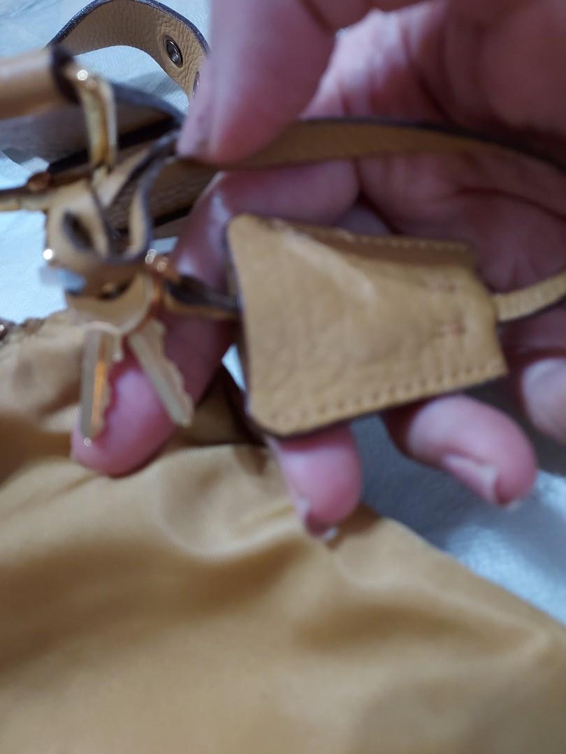 Prada Nylon Shoulder Bag (Category: Luxury Bags & Wallets) located in Paranaque City. Submitted by andim8 (Listing ID 1123053700, Image 3). Description: Authentic prada nylon sboulder bag in honey color. with auth card clochette padlock and keys. provided dustbag only. guaranteed authentic.