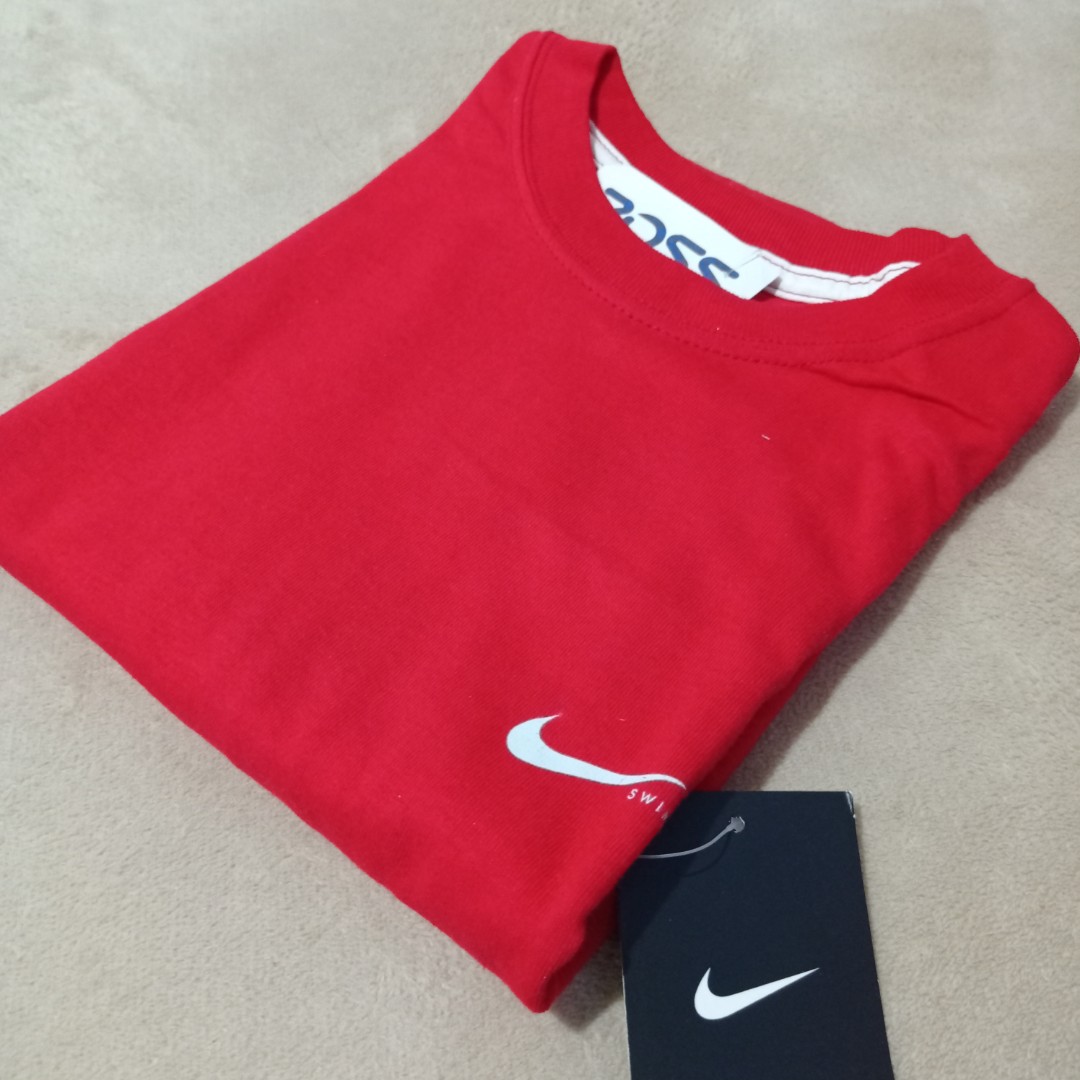 red nike shirt with black swoosh