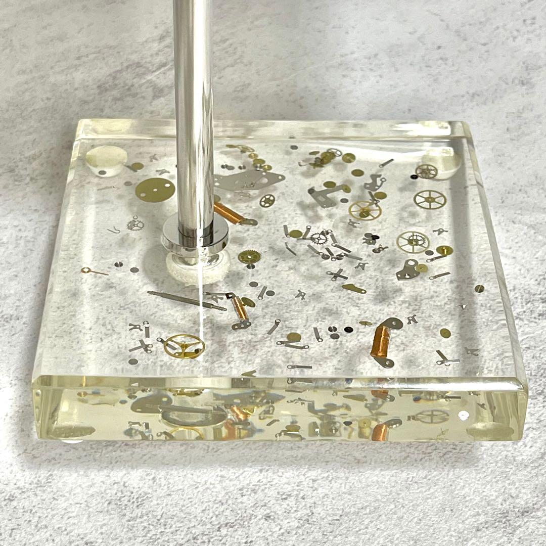 Watch Display Stand (Category: Accessory holder, box & organizers) located in Singapore. Submitted by allwatchstuff (Listing ID 1123100310, Image 7). Description: Beautiful piece of art display that holds your watch and bracelet. Base is made of acrylic with watch components set in it. Overall height: 15.5cm Holder to base height: 13.5cm Stand base (square): 10cm Holder: L 8.8cm, W 6.6cm Accessories in pictures are for display only. .