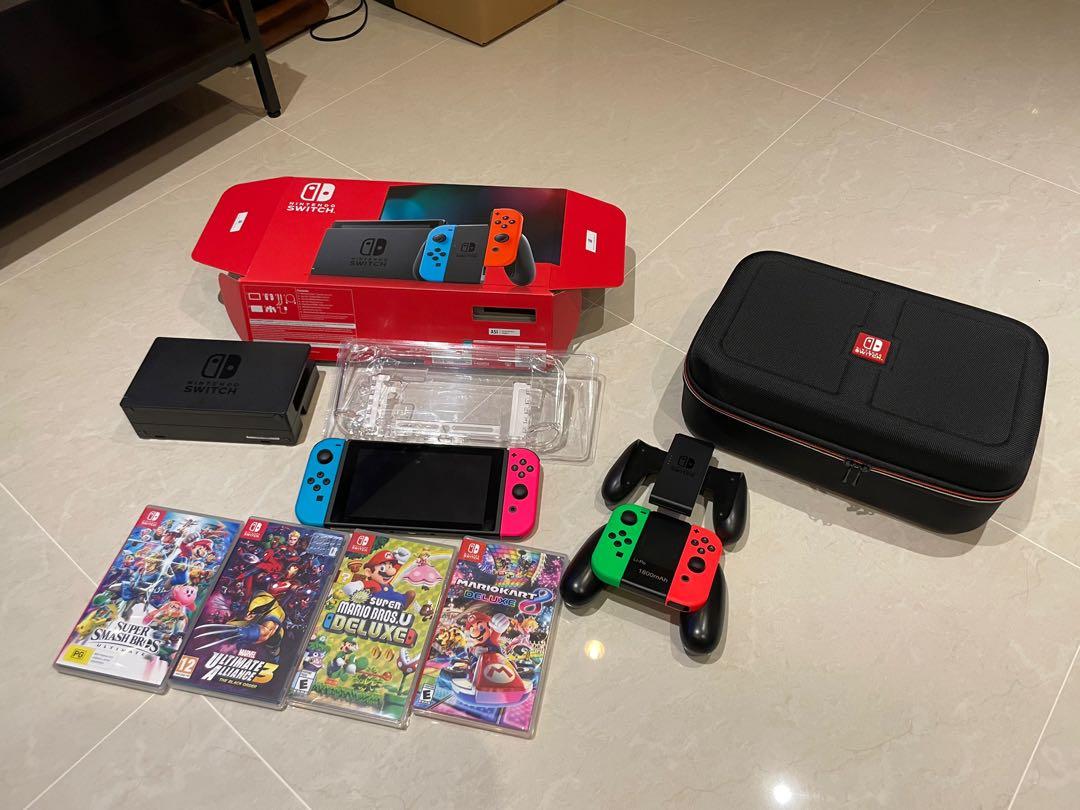 Nintendo Switch Bundle (Category: Nintendo) located in Singapore. Submitted by tm619 (Listing ID 1124043047, Image 1). Description: 1x Nintendo switch console in original package (original receipt available upon request) 4x small / 2x big joysticks 4x popular games (2x unopened / new) - worth over $250!! 1x high-quality travel bag 1x console protector case Used 6-7 times only over one year. Almost new!! Total price spent was over $1200. Selling a