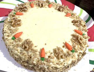Freshly baked, Yummy &Moist carrot cake with cream cheese frosting, made with walnuts, pineapple, raisins & baked with finest ingredients