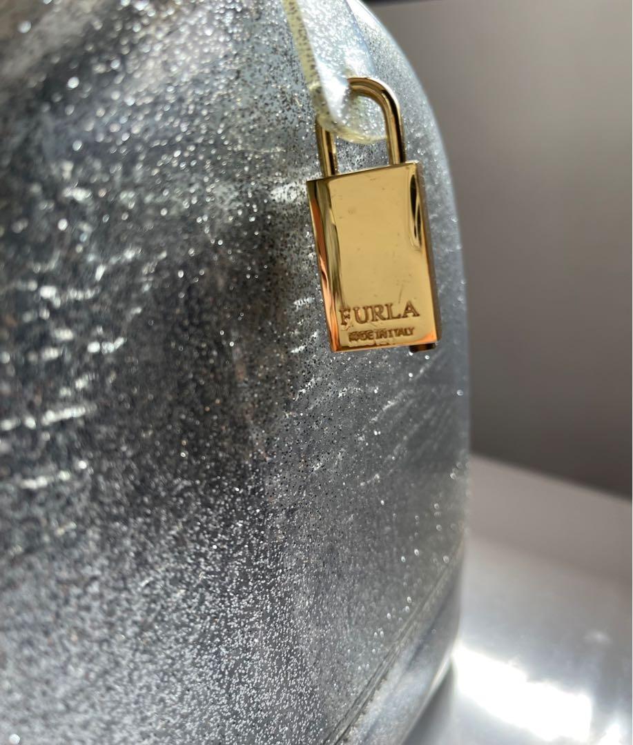 ❤️ Furla authentic sparkling siver jelly (Category: Luxury Bags & Wallets) located in Quezon City. Submitted by msgqmom (Listing ID 1130764161, Image 2). Description: With padlock & cards Please check the flaw at the end of the zipper & 2 dots of red ballpen Dust bag .