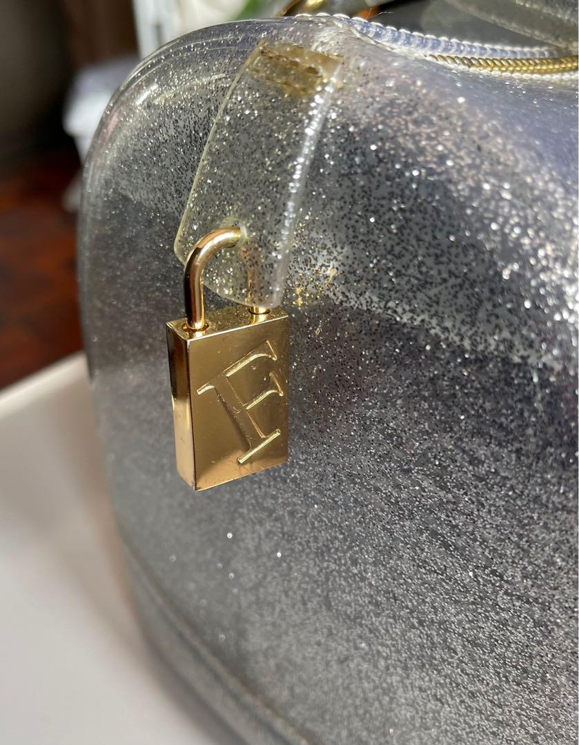 ❤️ Furla authentic sparkling siver jelly (Category: Luxury Bags & Wallets) located in Quezon City. Submitted by msgqmom (Listing ID 1130764161, Image 3). Description: With padlock & cards Please check the flaw at the end of the zipper & 2 dots of red ballpen Dust bag .