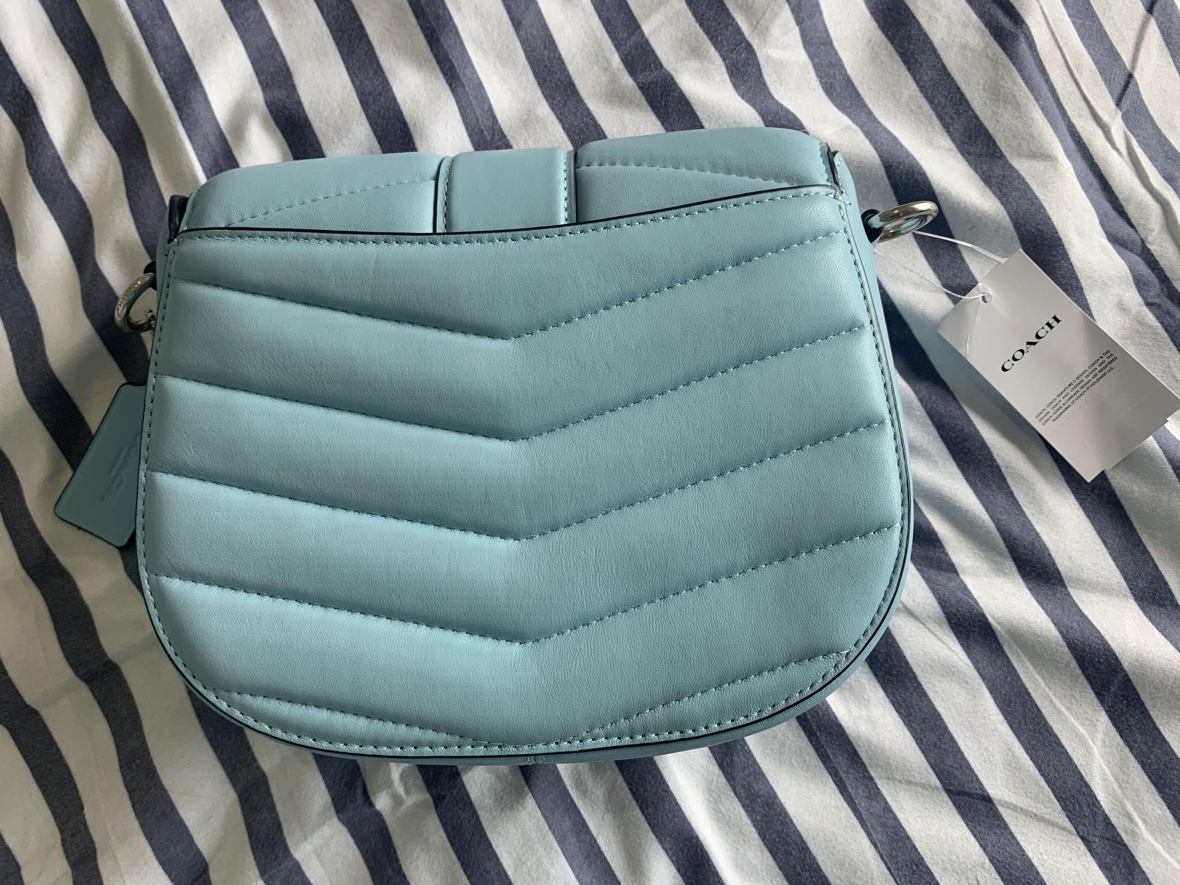 Coach Georgie Saddle Bag with Quilting (Category: Luxury Bags & Wallets) located in Calamba. Submitted by chaserstar (Listing ID 1130671551, Image 2). Description: RARE COLOR Coach Georgie Saddle Bag with Quilting in Waterfall color and silver hardware Bought from Canada Brand new and unused Nappa leather and smooth leather Inside multifunction pockets Snap closure, fabric lining Outside open pocket Detachable strap with 20 3/4" drop for shoulder