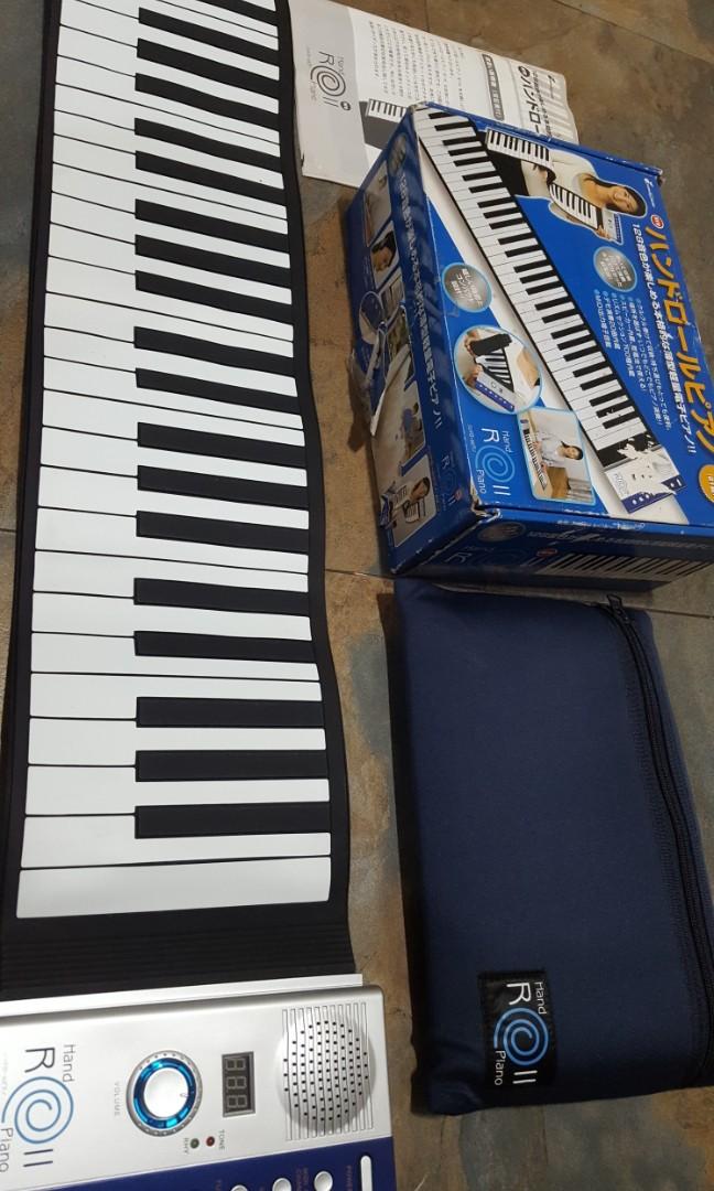 Piano Hand Roll 61 Keys (Category: Musical Instruments) located in Binangonan. Submitted by stufflikedat (Listing ID 1130923818, Image 1). Description: Ginza Yamano Music (Japan) hand roll piano 61 keys, 128 tones,100 rhythm,20 demo tunes, all keys are functioning, complete with power adaptor 110V, manual in japanese & english, carry bag and box. can be rolled & can be played using AA batteries.like new condition for 2.8k.