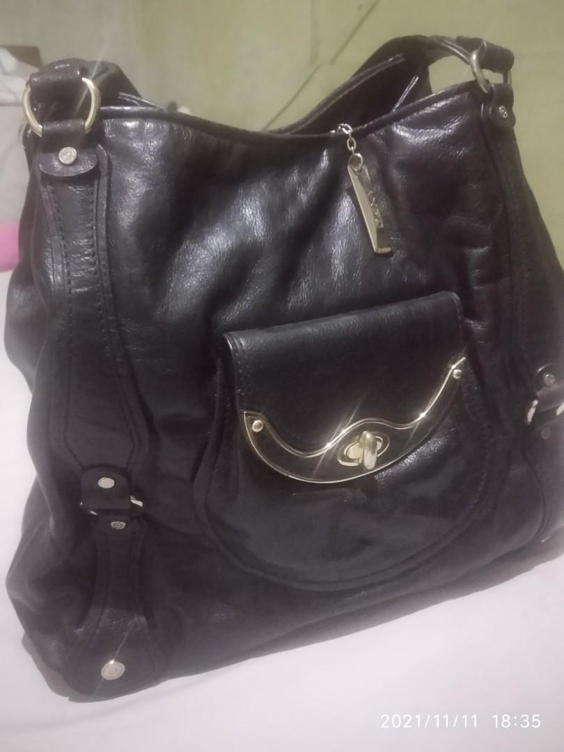 DKNY Tote black pure leather (Category: Luxury Bags & Wallets) located in Pasig City. Submitted by debfallar (Listing ID 1132309003, Image 2). Description: Original DKNY black leather tote for women on the go. Spacious but not bulky. It goes well with any casual outfit. Rarely used. All original with dust bag. Used only twice Specs: 13inH x 16inW x 5in Base. Handle Drop: 8.5in RFS: decluttering Mode of payment: GCash, Paymaya, BPI..