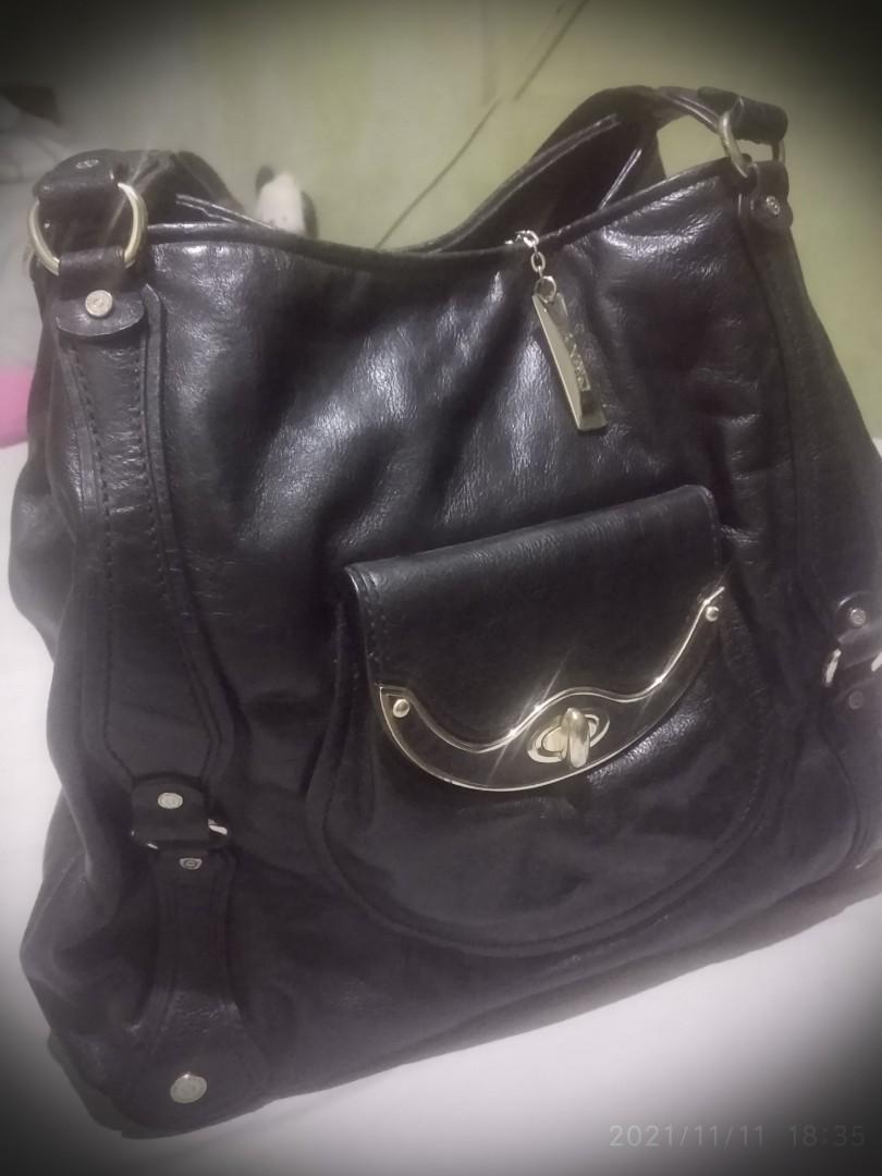 DKNY Tote black pure leather (Category: Luxury Bags & Wallets) located in Pasig City. Submitted by debfallar (Listing ID 1132309003, Image 1). Description: Original DKNY black leather tote for women on the go. Spacious but not bulky. It goes well with any casual outfit. Rarely used. All original with dust bag. Used only twice Specs: 13inH x 16inW x 5in Base. Handle Drop: 8.5in RFS: decluttering Mode of payment: GCash, Paymaya, BPI..
