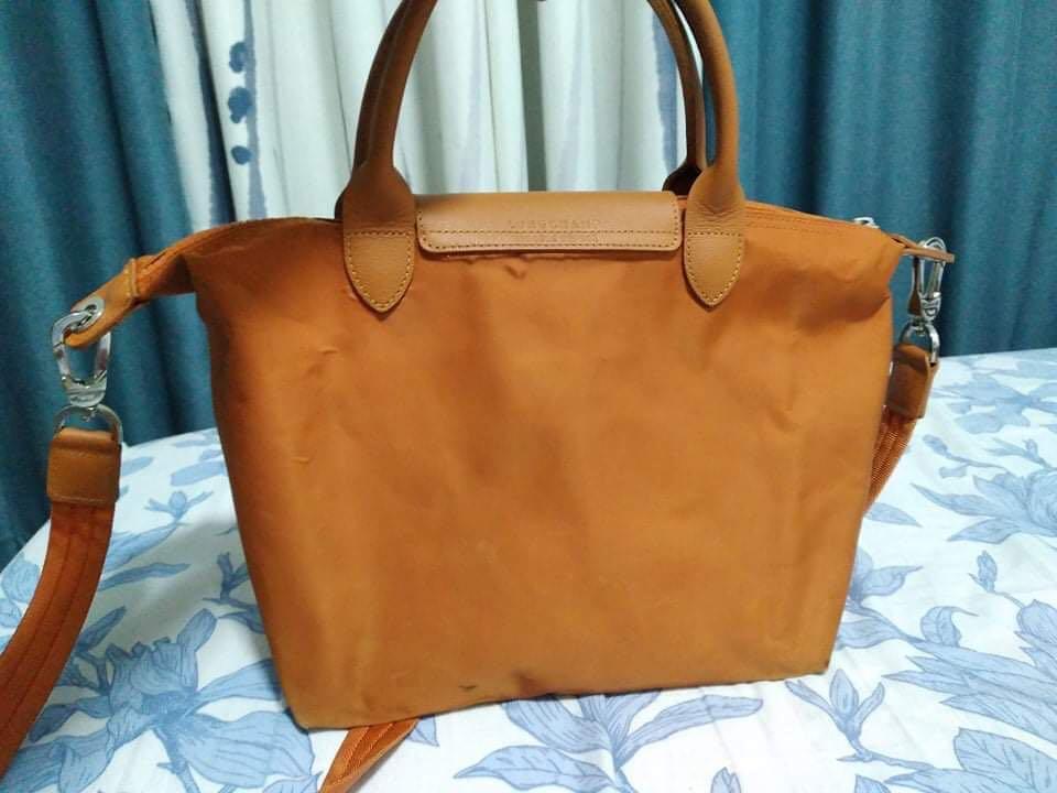 Longchamp shoulder bag (Category: Luxury Bags & Wallets) located in Quezon City. Submitted by shiegarcia22 (Listing ID 1132320776, Image 2). Description: Sling bag/handbag Brand: Longchamp Condition: preloved Color: orange Height: 10 inches Width: 7 inches Length: 15 inches Flaws: stains.