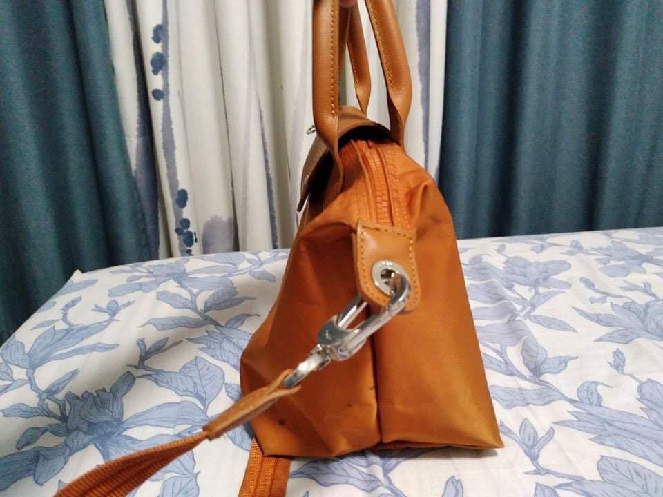 Longchamp shoulder bag (Category: Luxury Bags & Wallets) located in Quezon City. Submitted by shiegarcia22 (Listing ID 1132320776, Image 3). Description: Sling bag/handbag Brand: Longchamp Condition: preloved Color: orange Height: 10 inches Width: 7 inches Length: 15 inches Flaws: stains.