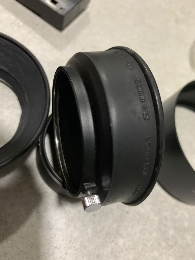 Rare original Olympus OM lens hood for three focal lengths. Four hoods
