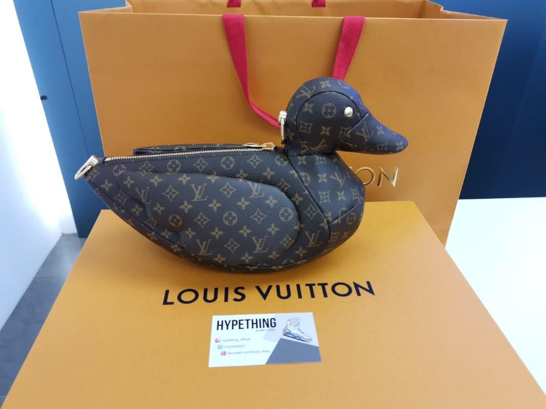 Alex Domenec poses with a Louis Vuitton X Nigo duck bag before the