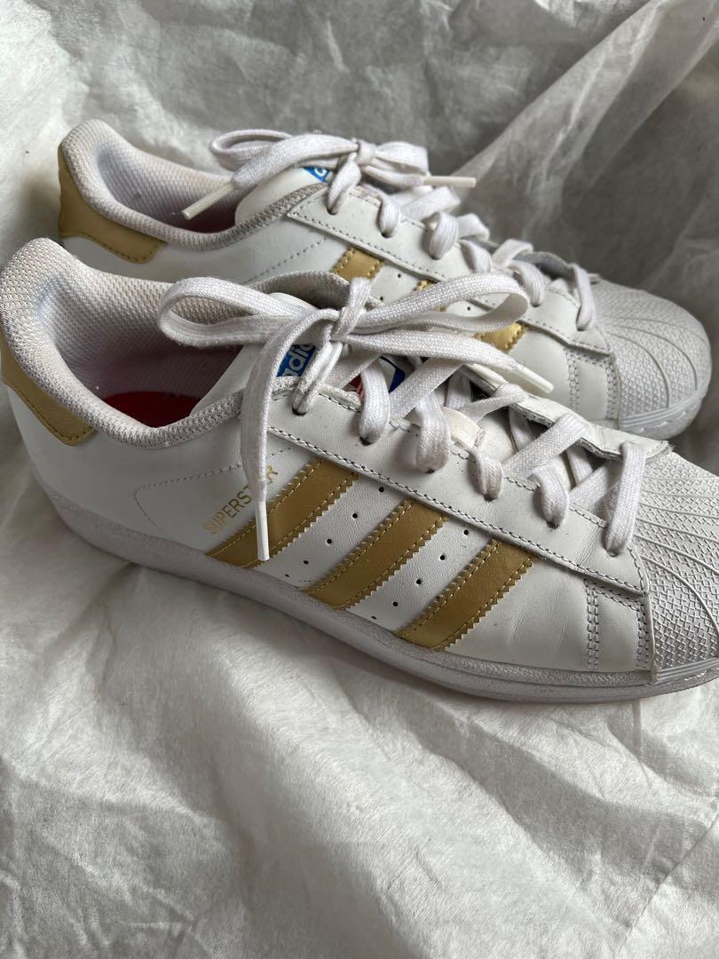Womens adidas with gold stripes hotsell