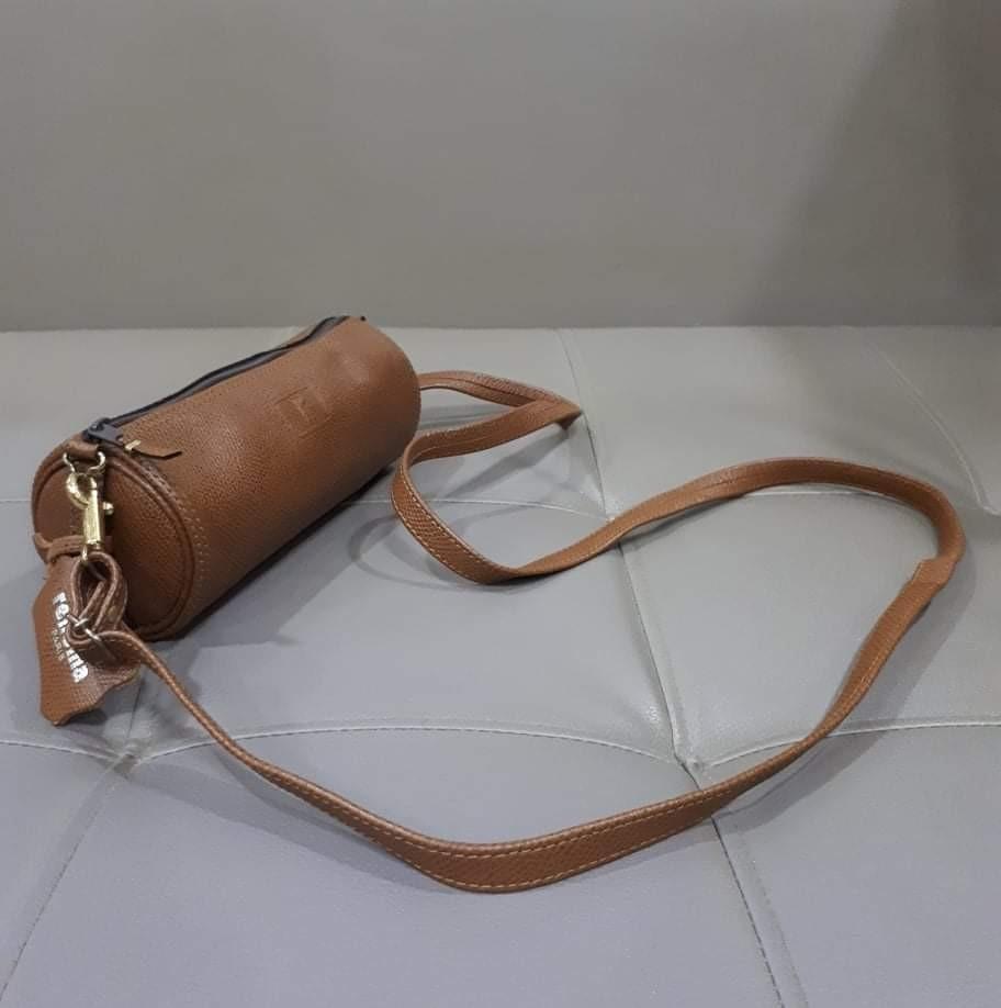 Renoma Nano Sling Bag (Category: Luxury Bags & Wallets) located in Taguig. Submitted by esa.agustin (Listing ID 1130462002, Image 2). Description: Otiginal Renoma brown leather barrel shaped sling bag. Length: 7.4 inches.