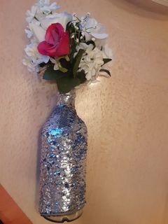 9.5" tall bottle vase with sequin sleeve and artificial flowers