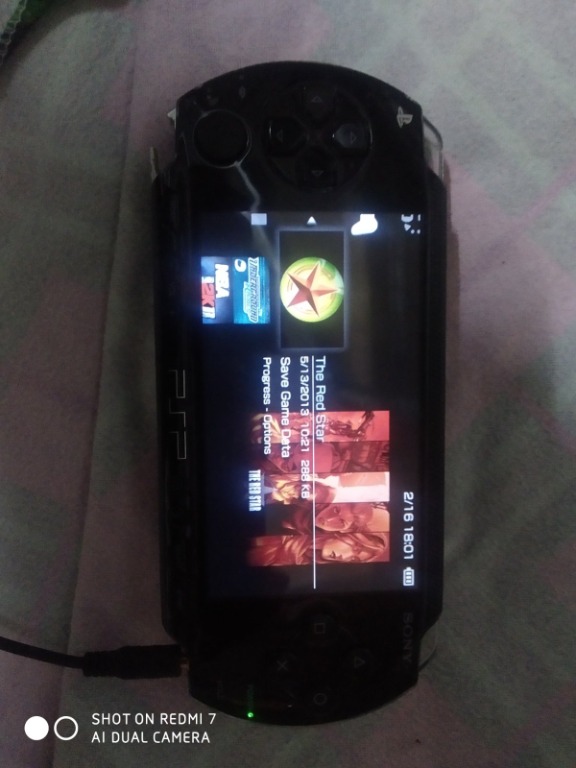 SONY PSP 1001 including charger case pre installed games. As is