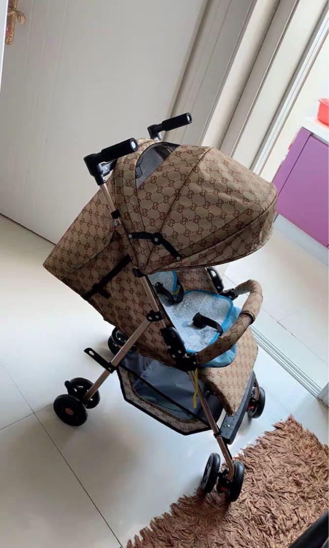 Brown colour with Gucci logo stroller