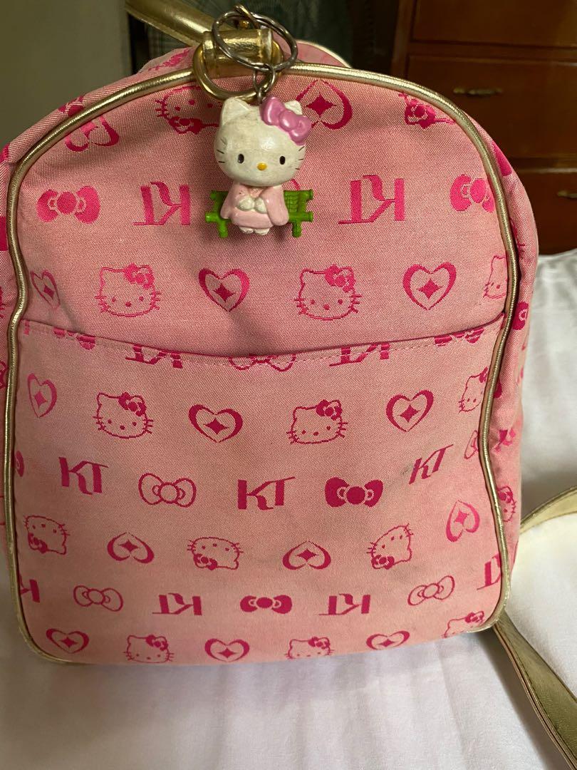 💯 Authentic Sanrio Hello Kitty Duffle bag with strap (Category: Cross-body Bags) located in Quezon City. Submitted by irenerc (Listing ID 1071382144, Image 2). Description: 💯 Authentic. Please see photos for flaws. Needs minor cleaning. Overall the bag is sturdy and trendy. Color is pink and gold accent and strap. Rfs decluttering .
