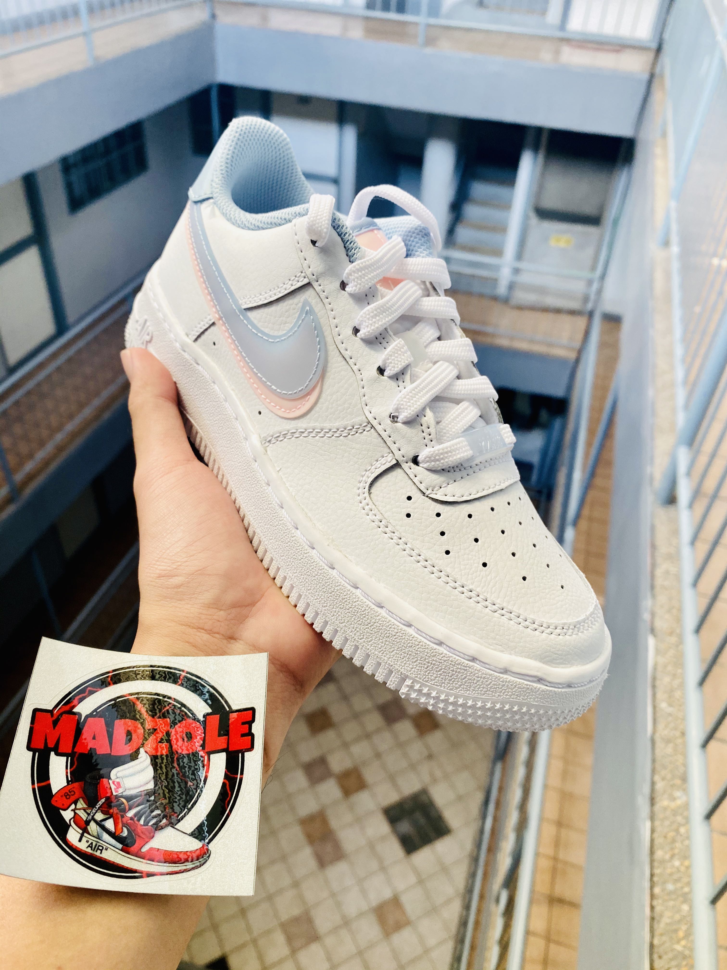 white air forces with pink and blue nike sign