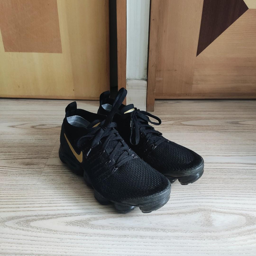 Black vapormax store with gold tick
