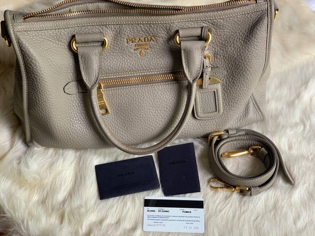 Authentic Prada Bag (Category: Luxury Bags & Wallets) located in Quezon City. Submitted by kimhailey (Listing ID 1075351180, Image 1). Description: Authentic💯 with entrupy certificate Prada Bag - Vitello Daino in Pomice condition: 8/10 with minimal flaws see pic 7 & 8 inclusion of strap, cards & dust bag Rfs: decluttering.