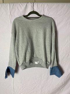 Grey jumper with blue cuffs